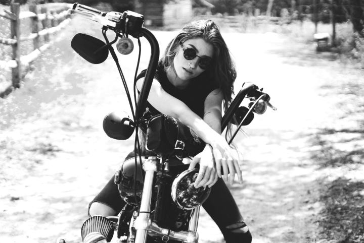 texas Outlaw Biker girl — A hot young woman sits astride a motorcycle in the Texas Hill Country Hot rod art print for sale.